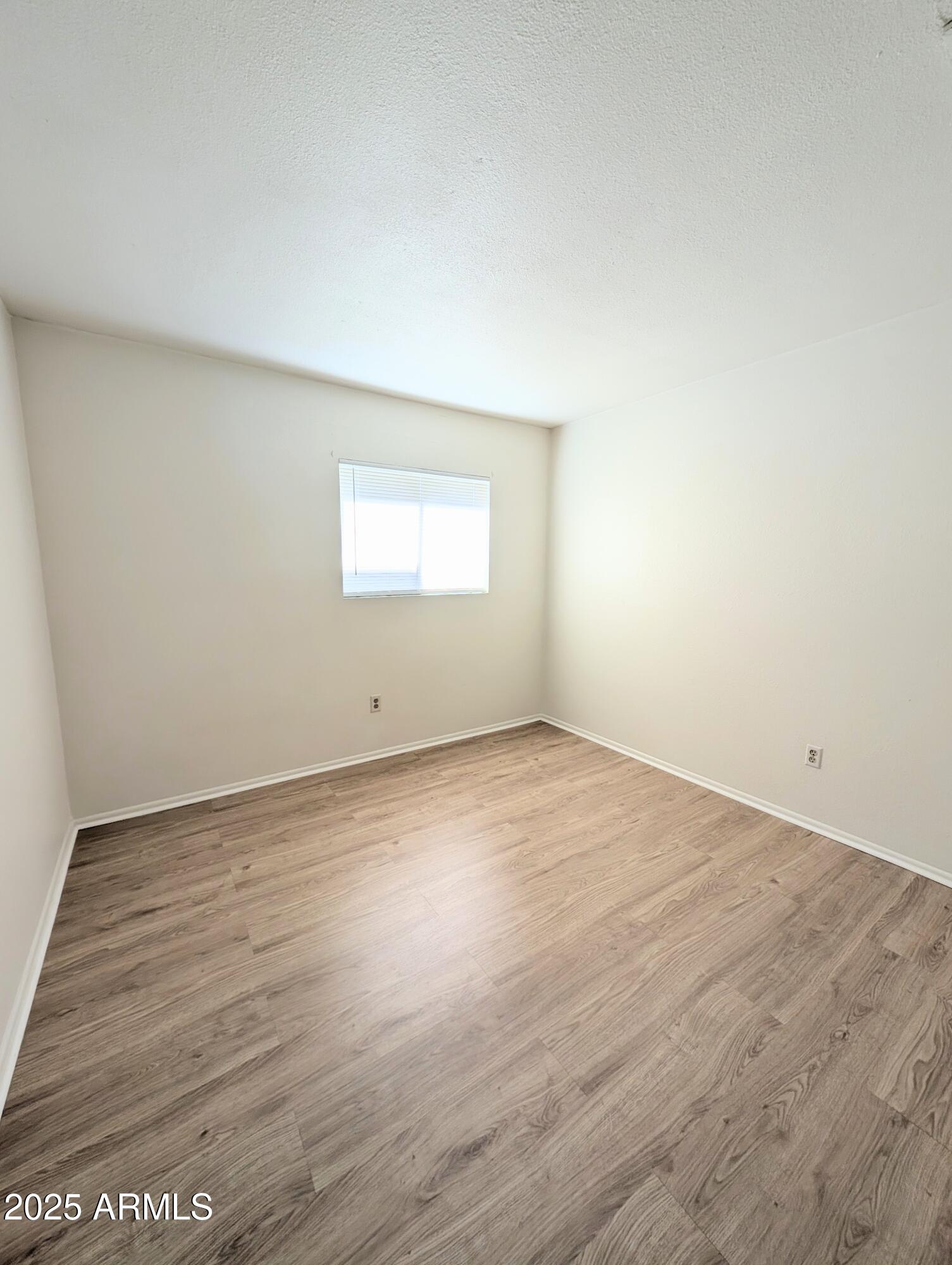 Undisclosed Address Chandler, AZ 85225 - Photo 17 of 21 an empty room with wooden floor and windows