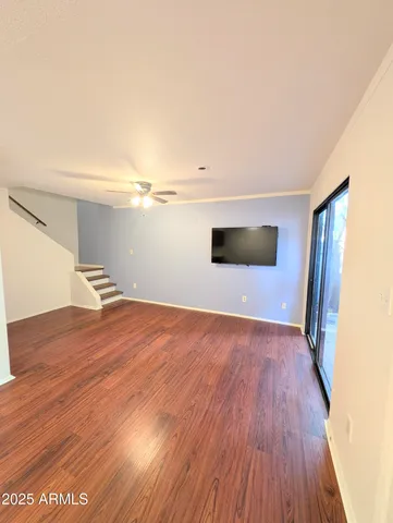 a view of empty room with wooden floor