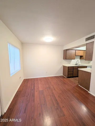 a room with a wooden floor and furniture
