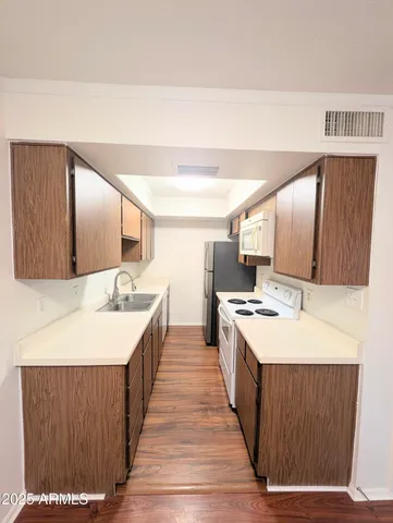 a large kitchen with a stove and a sink