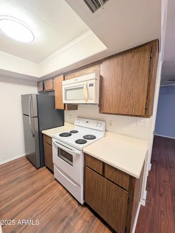 a kitchen with a stove a refrigerator and a sink