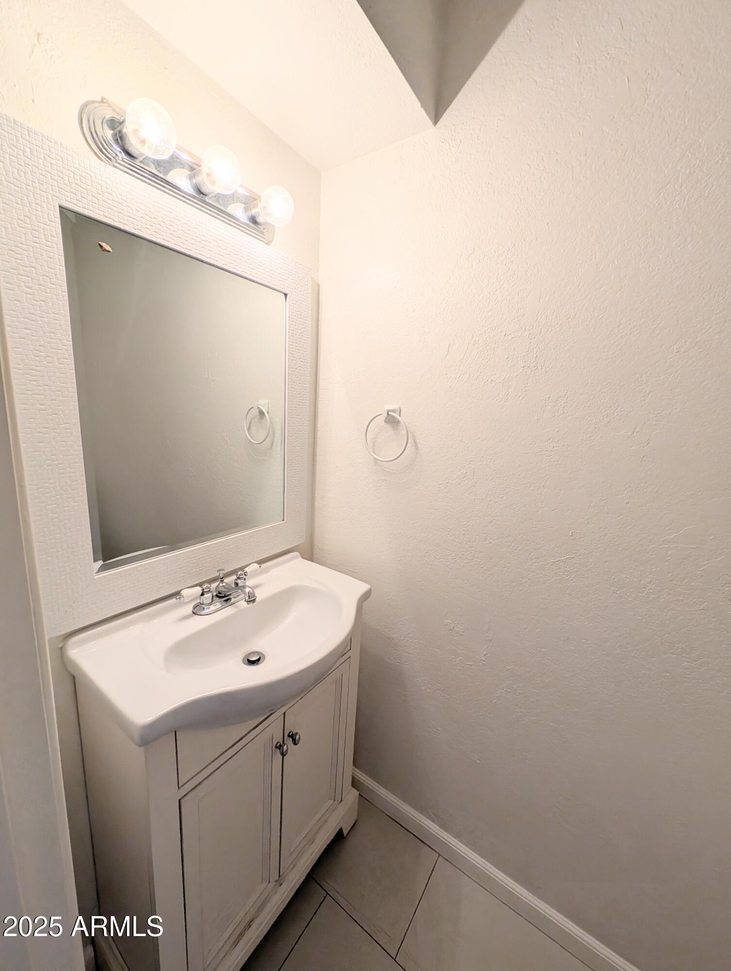 Undisclosed Address Chandler, AZ 85225 - Photo 9 of 21 a bathroom with a sink and mirror