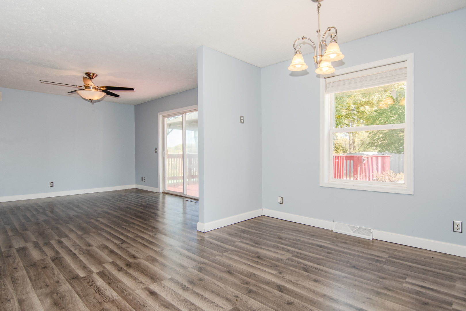 2970 North Dwight Road Morris, IL 60450 - Photo 24 of 43 an empty room with wooden floor chandelier fan and windows