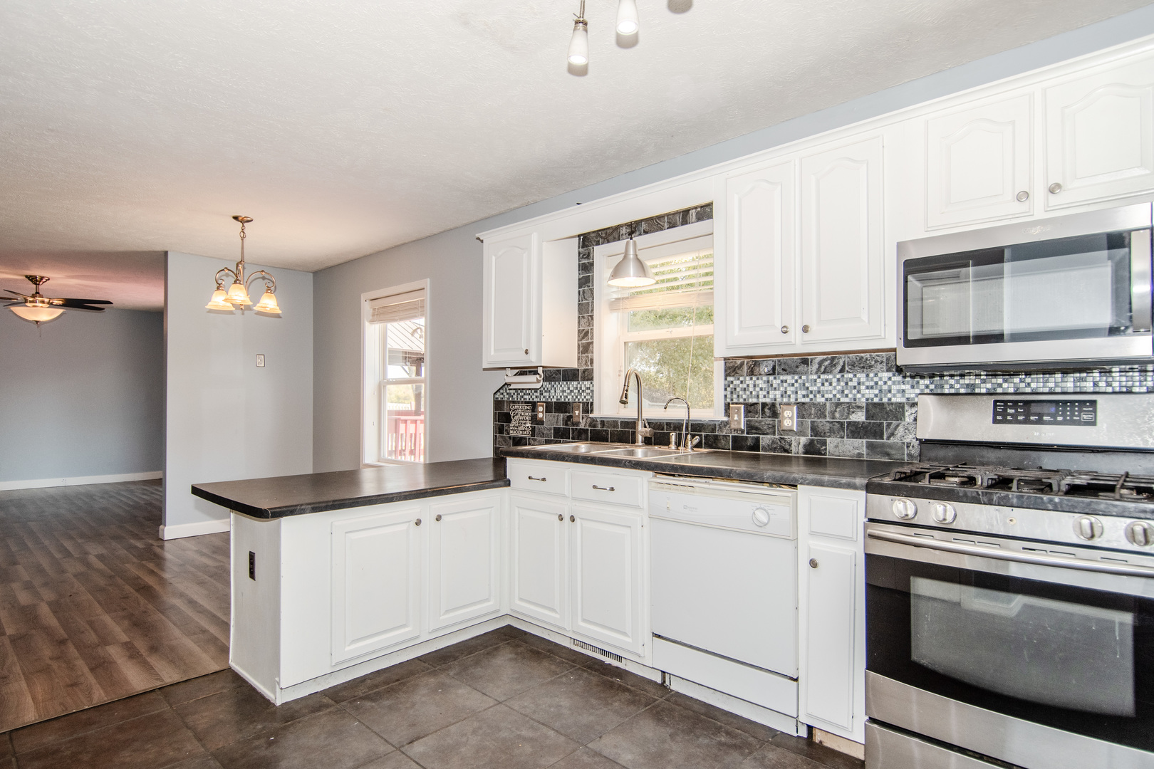 2970 North Dwight Road Morris, IL 60450 - Photo 26 of 43 a kitchen with granite countertop a sink stove and cabinets