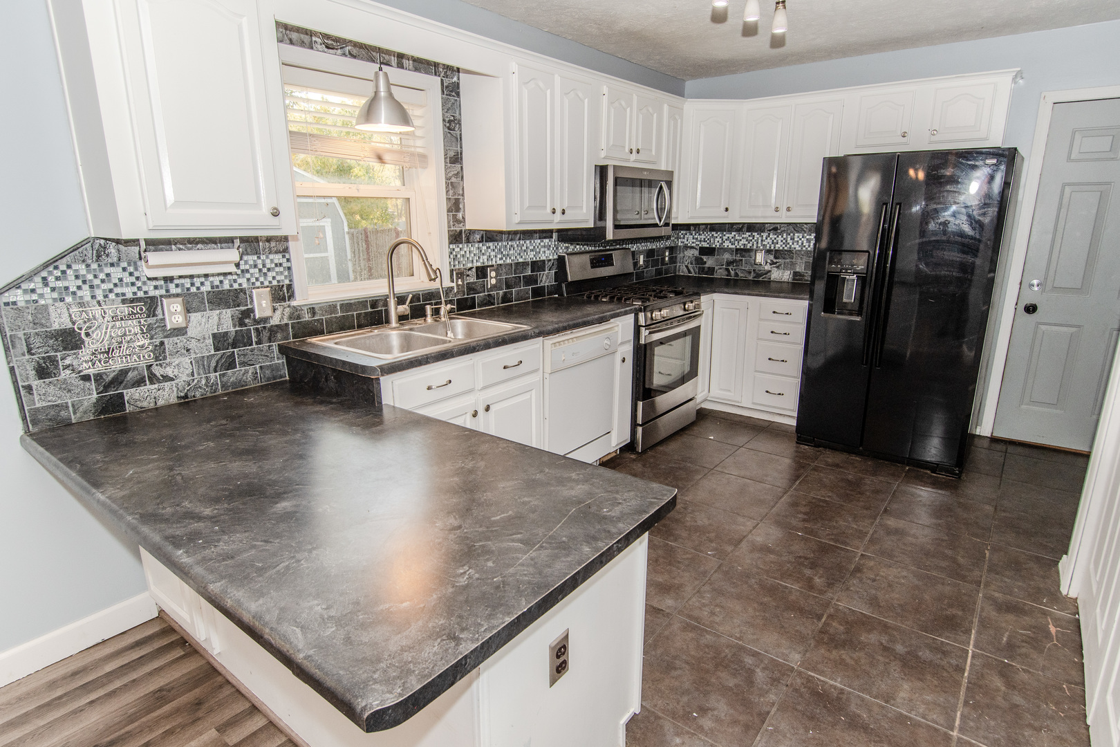 2970 North Dwight Road Morris, IL 60450 - Photo 29 of 43 a kitchen with stainless steel appliances granite countertop a sink a stove and a refrigerator