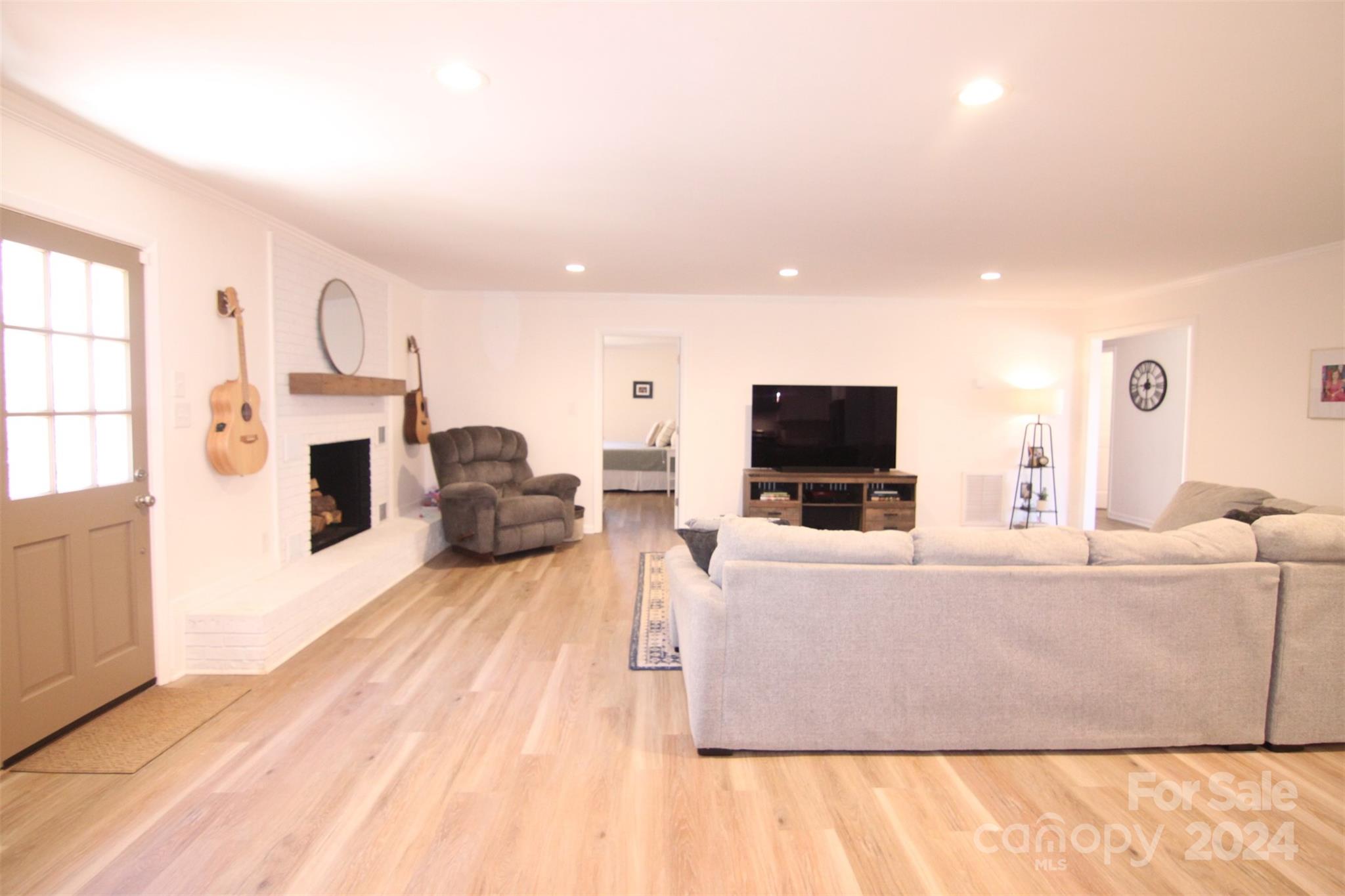 737 Miles Road Dallas, NC 28034 - Photo 22 of 47 a living room with furniture a flat screen tv and a fireplace