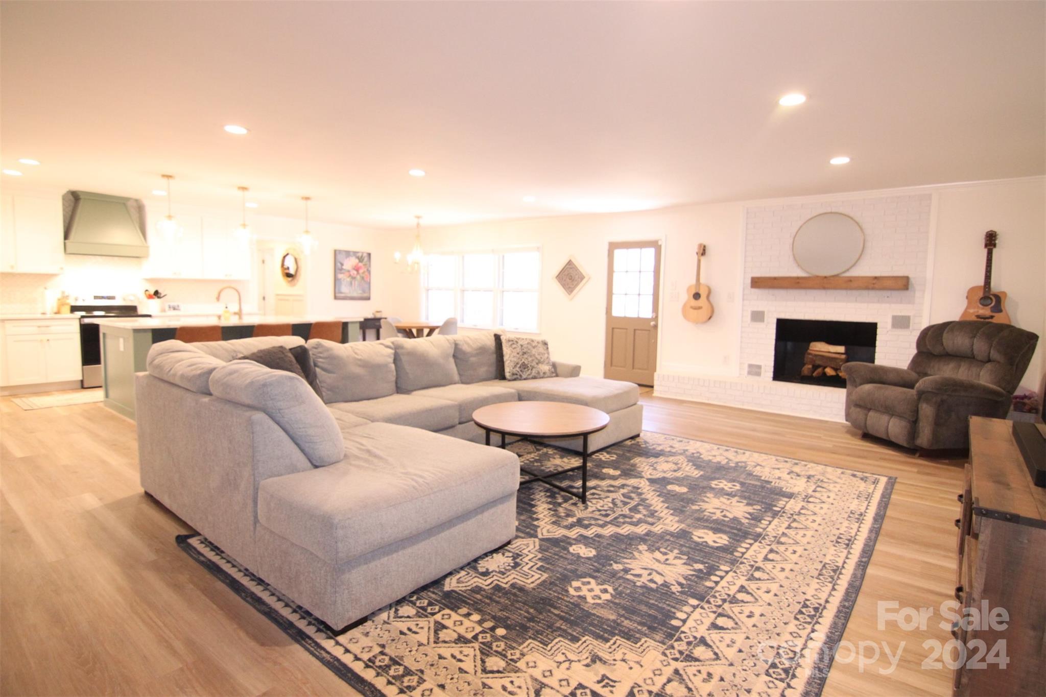 737 Miles Road Dallas, NC 28034 - Photo 25 of 47 a living room with furniture a fireplace and a table