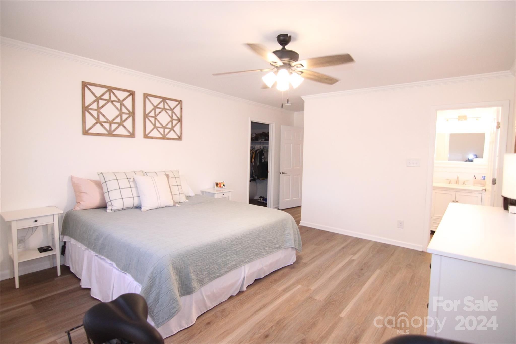 737 Miles Road Dallas, NC 28034 - Photo 32 of 47 a bedroom with a large bed and a chandelier