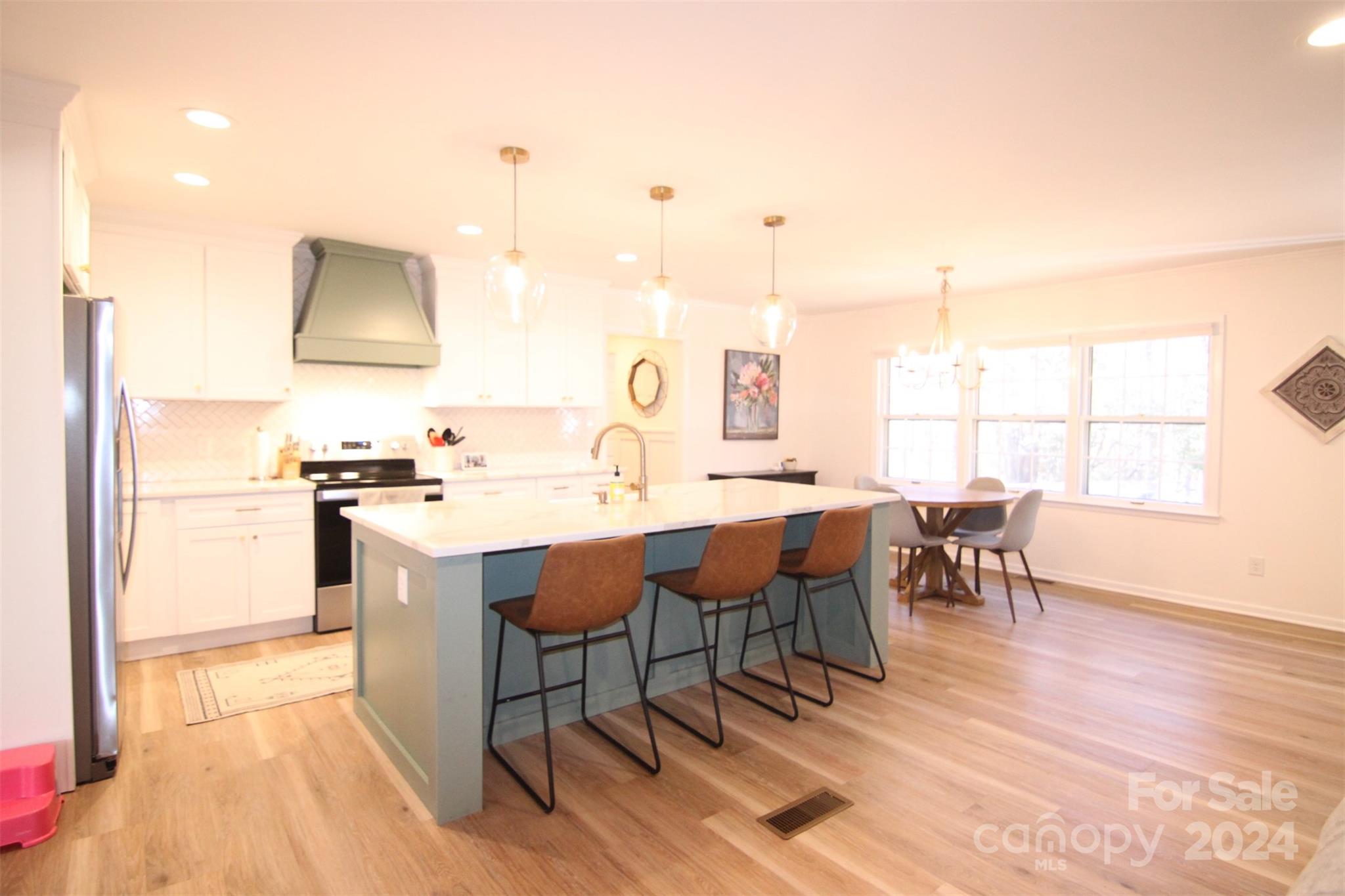 737 Miles Road Dallas, NC 28034 - Photo 9 of 47 a kitchen with a dining table chairs and sink