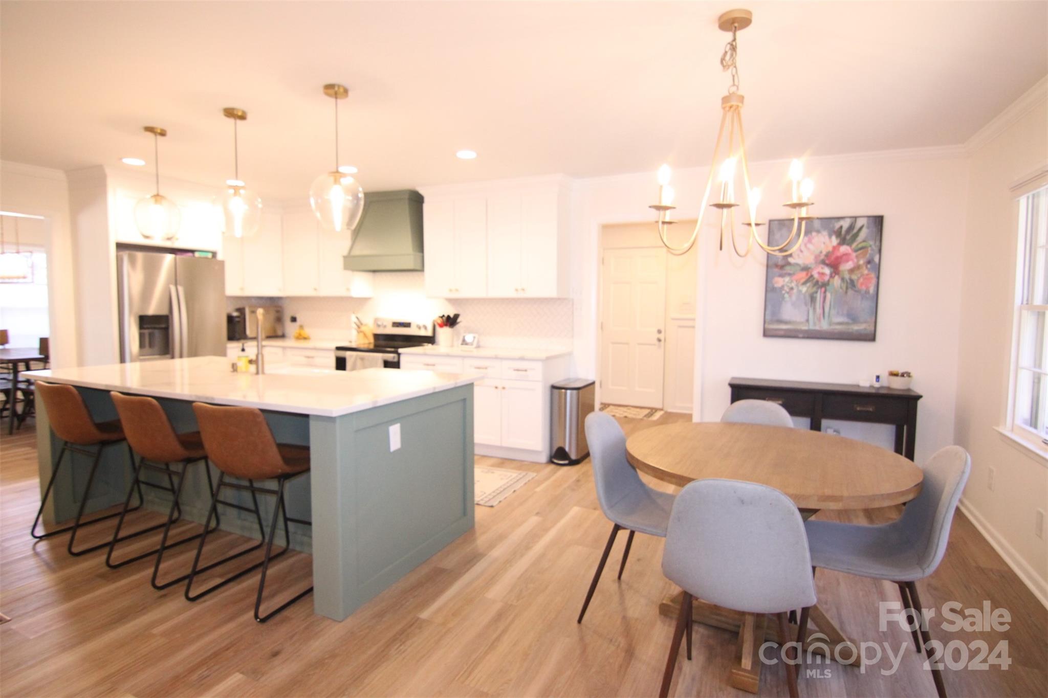 737 Miles Road Dallas, NC 28034 - Photo 10 of 47 a large kitchen with a table chairs and counter space