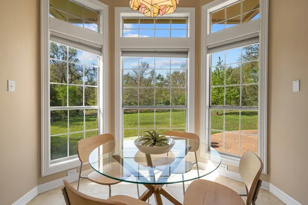a dining room with glass windows and table