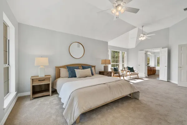 a bedroom with bed and a chandelier