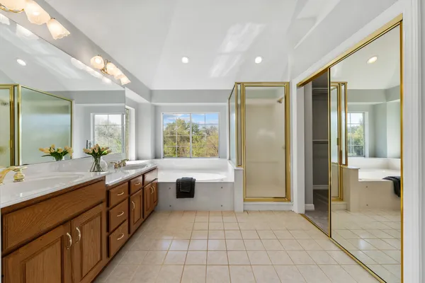 a large bathroom with a large tub shower and sink