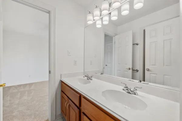 a bathroom with a sink a vanity and a mirror