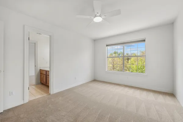 an empty room with windows and closet