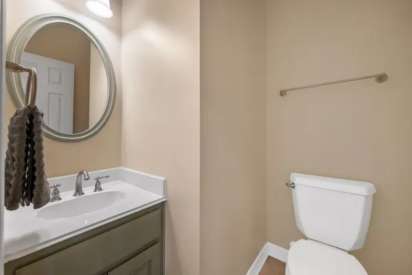 a bathroom with a toilet a sink and mirror