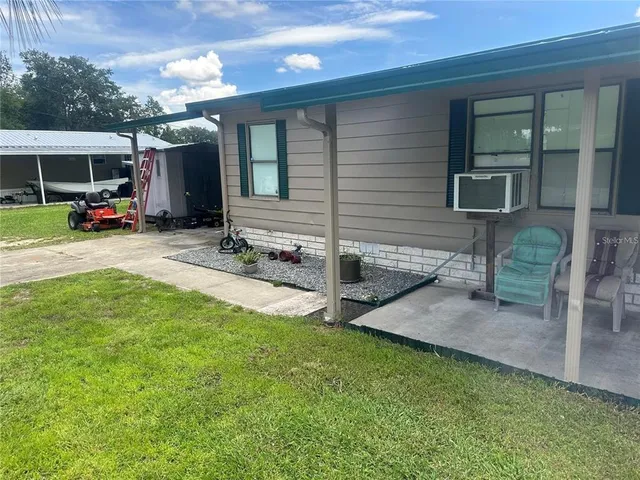 a view of a house with backyard and porch