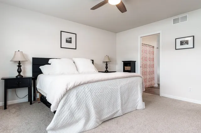 a bedroom with a bed and a chandelier