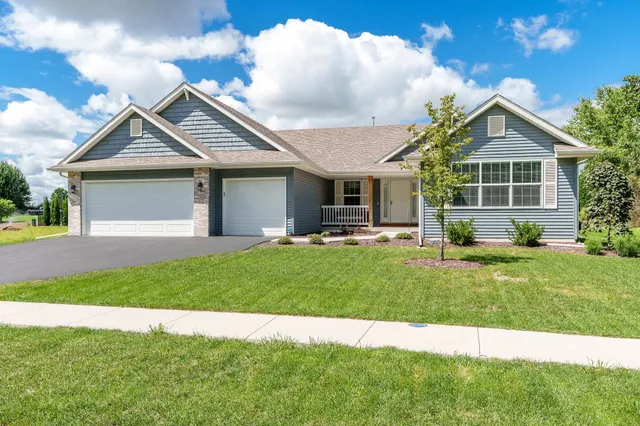 a front view of a house with a yard and garage