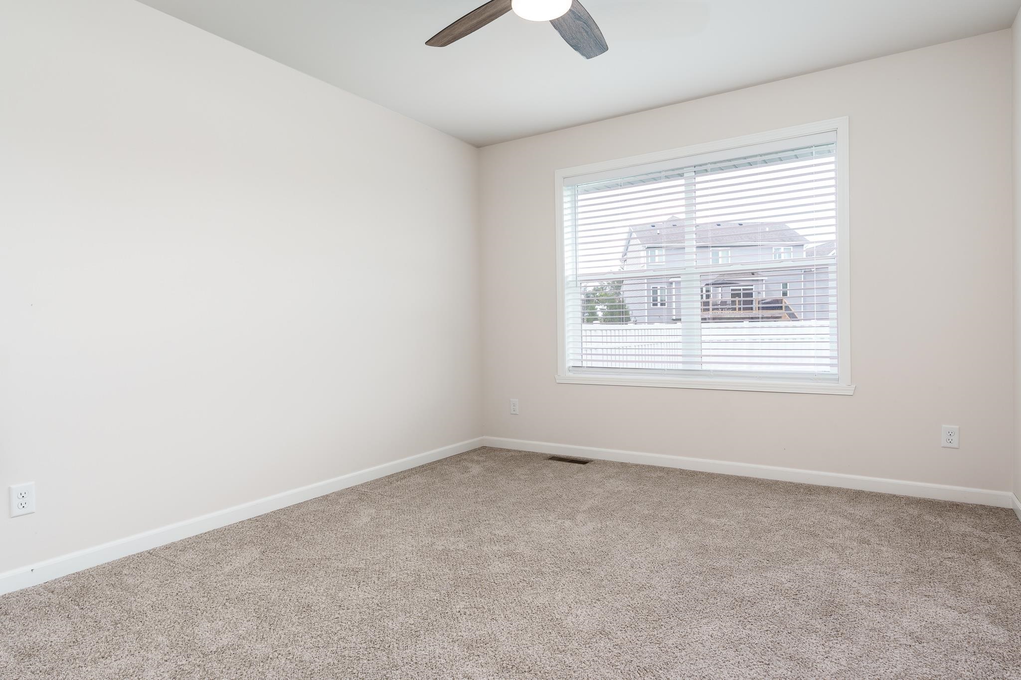 779 Boz Way Belvidere, IL 61008 - Photo 21 of 39 an empty room with a window and a ceiling fan