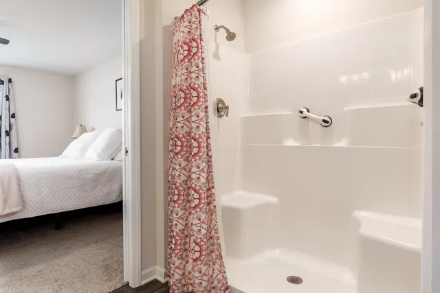 a bathroom with a bathtub and shower