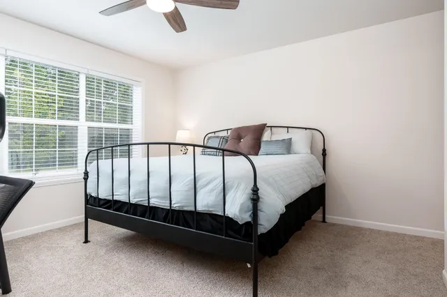 a bed sitting in a room next to a window