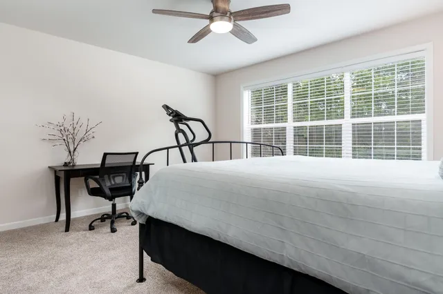 a bedroom with a bed and a window