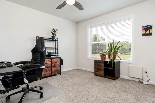a view of workspace with furniture and windows