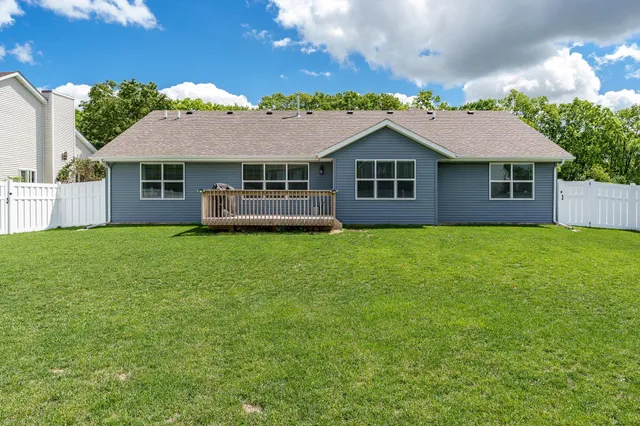 a view of a house with a yard and deck