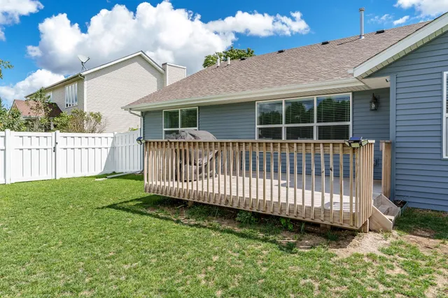 a view of balcony with wooden floor and fence