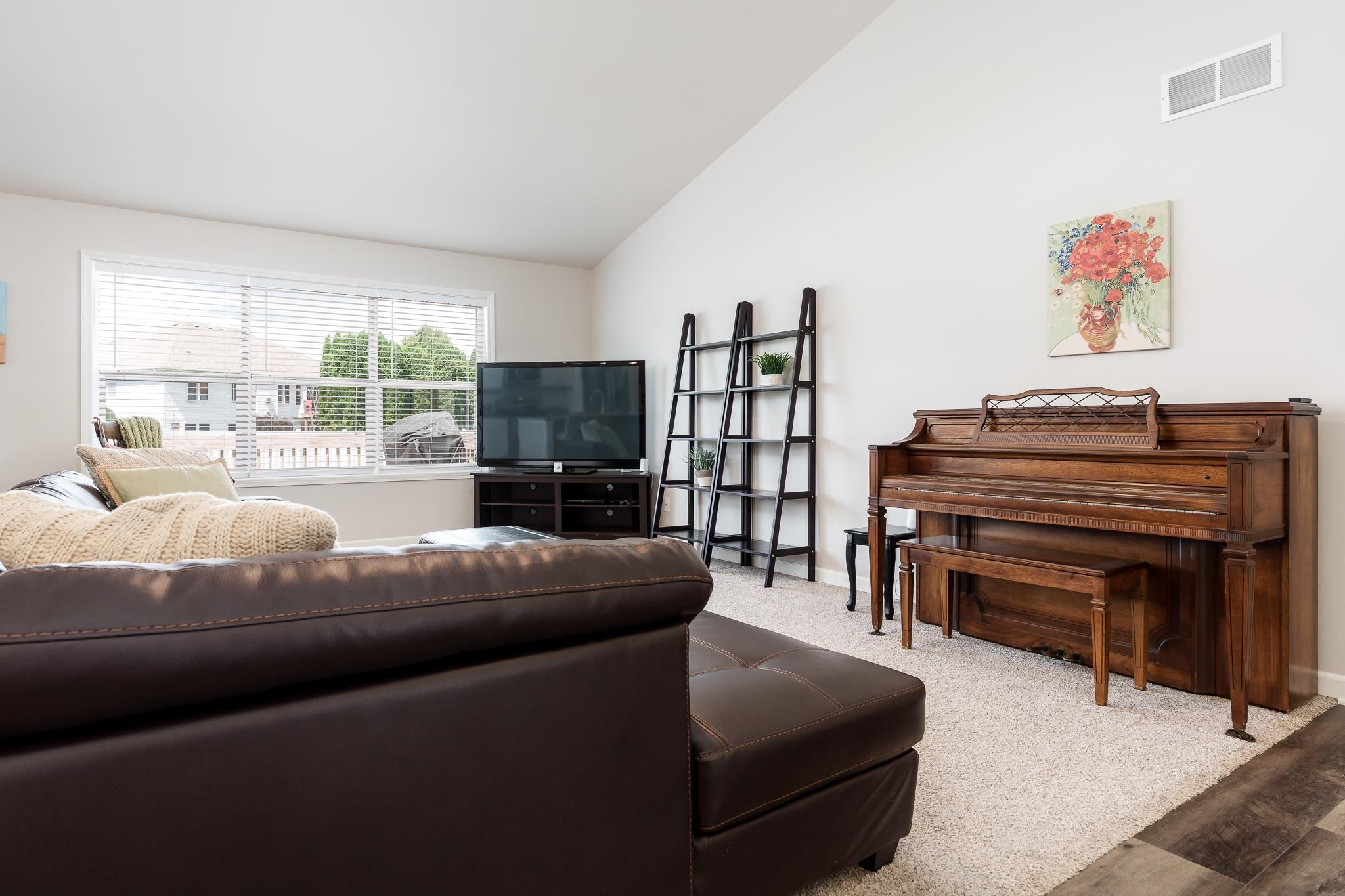 779 Boz Way Belvidere, IL 61008 - Photo 37 of 39 a living room with furniture a large window and a flat screen tv