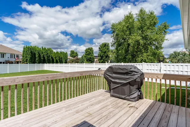 a view of a wooden deck and a yard