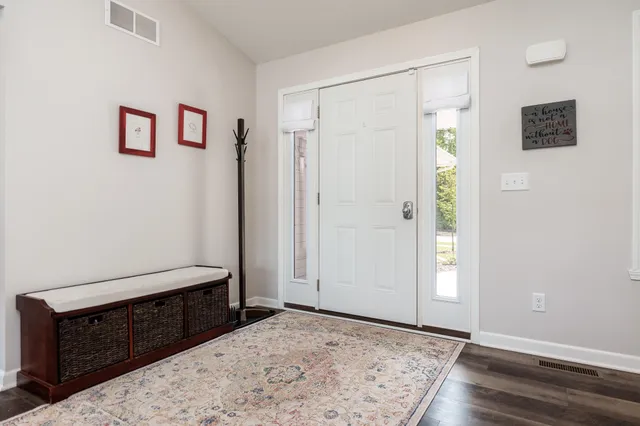 a view of a bedroom with closet and mirror