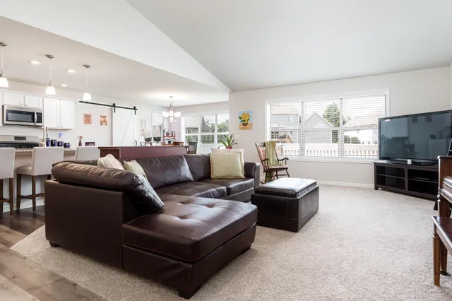 a living room with furniture and a kitchen