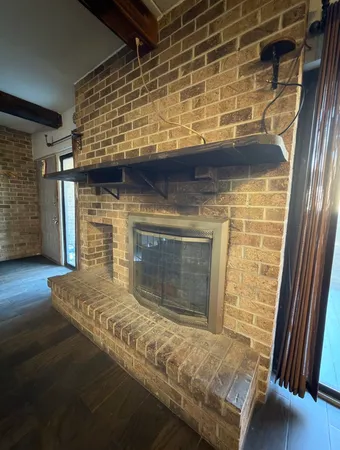 a view of fireplace and wooden floor