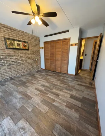 a view of a livingroom with a ceiling fan and a hardwood floor