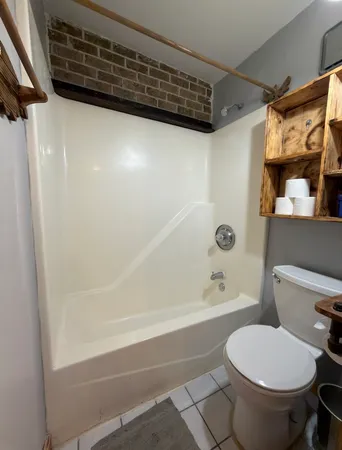 a bathroom with a toilet and a shower