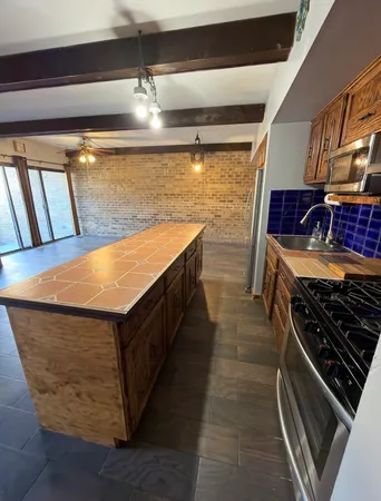 a kitchen with stainless steel appliances granite countertop a stove and a sink