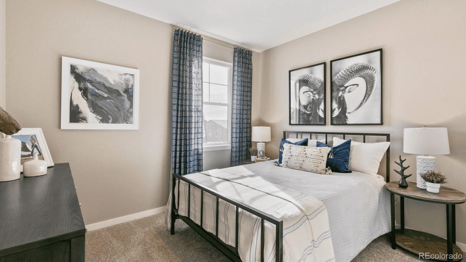 810 North Clubview Street Watkins, CO 80137 - Photo 13 of 21 a bedroom with a large bed and a window