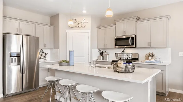 a kitchen with stainless steel appliances a sink stove and refrigerator
