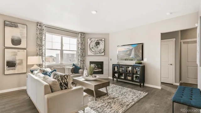 a living room with furniture a fireplace and window