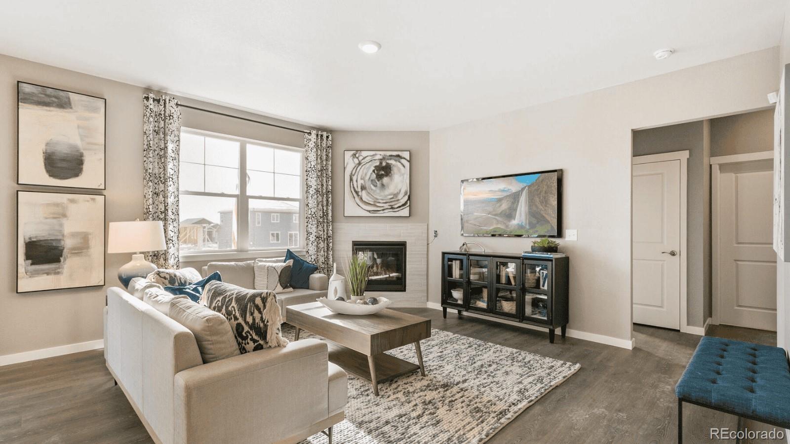 810 North Clubview Street Watkins, CO 80137 - Photo 9 of 21 a living room with furniture a fireplace and window
