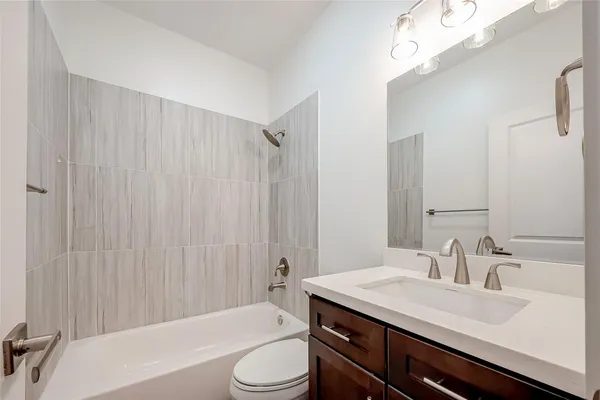 a bathroom with a sink a light fixture and a mirror