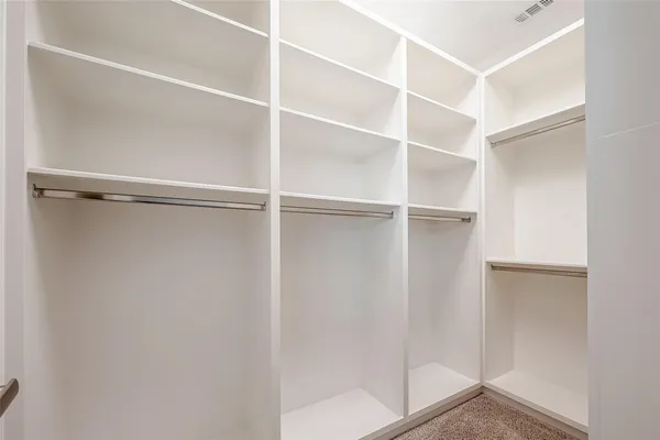 a view of an empty room with a fireplace and a window