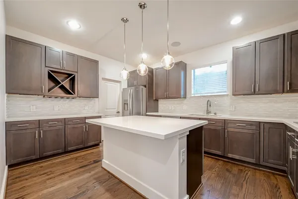 a kitchen with a sink cabinets and wooden floor