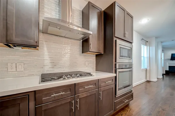 a kitchen with stainless steel appliances granite countertop a refrigerator and a stove