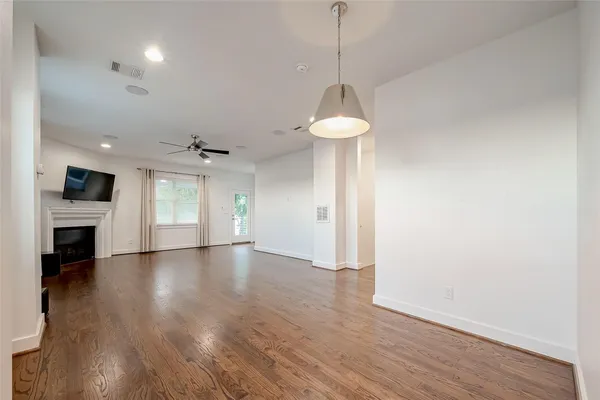 a view of an empty room with a fireplace and a window