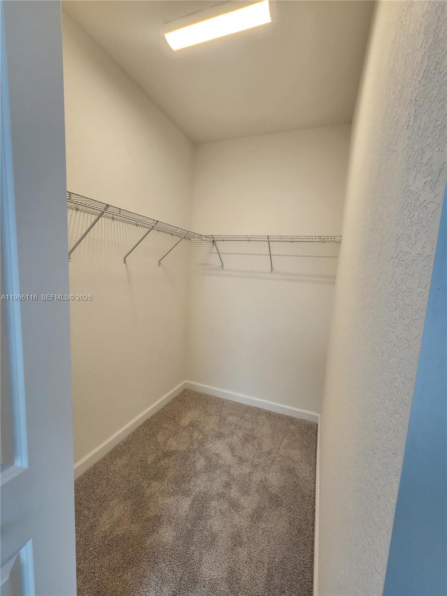 23331 Southwest 128th Avenue, Unit 23331 Homestead, FL 33032 - Photo 11 of 16 a view of a room with racks on the wall