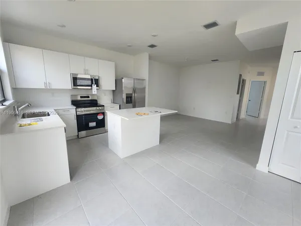 a room with cabinets and white appliances
