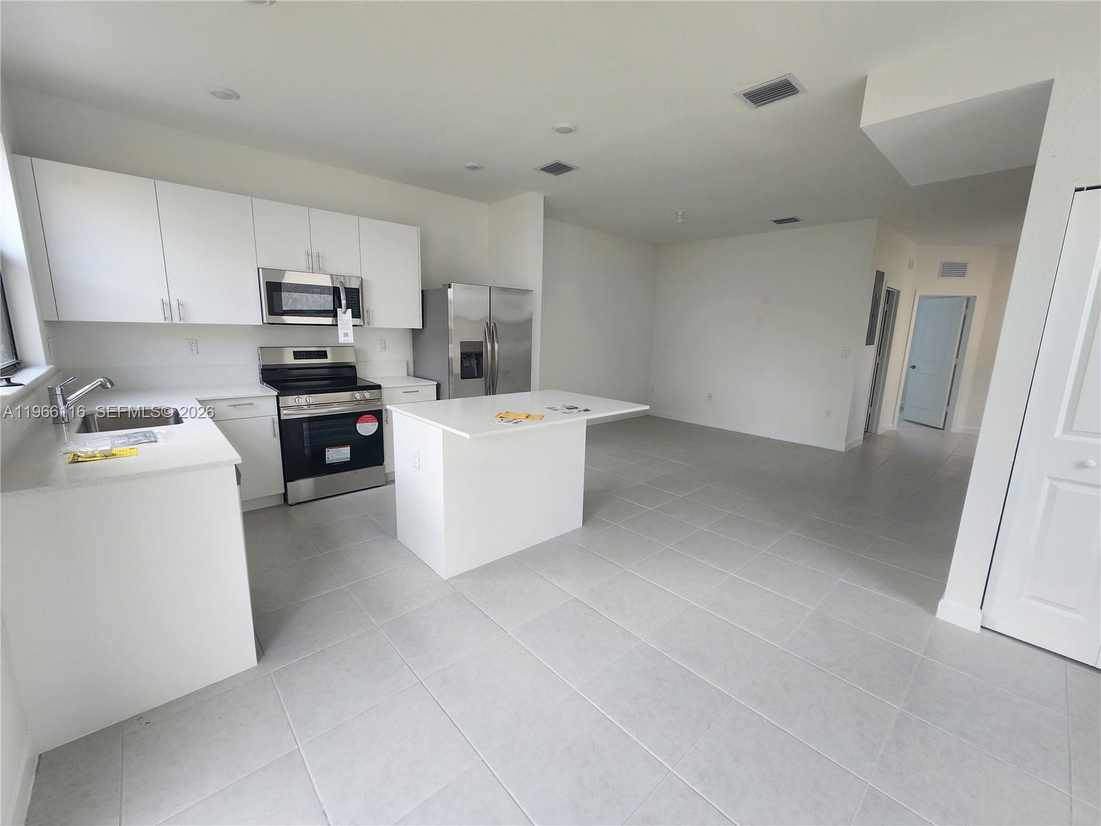 23331 Southwest 128th Avenue, Unit 23331 Homestead, FL 33032 - Photo 5 of 16 a room with cabinets and white appliances